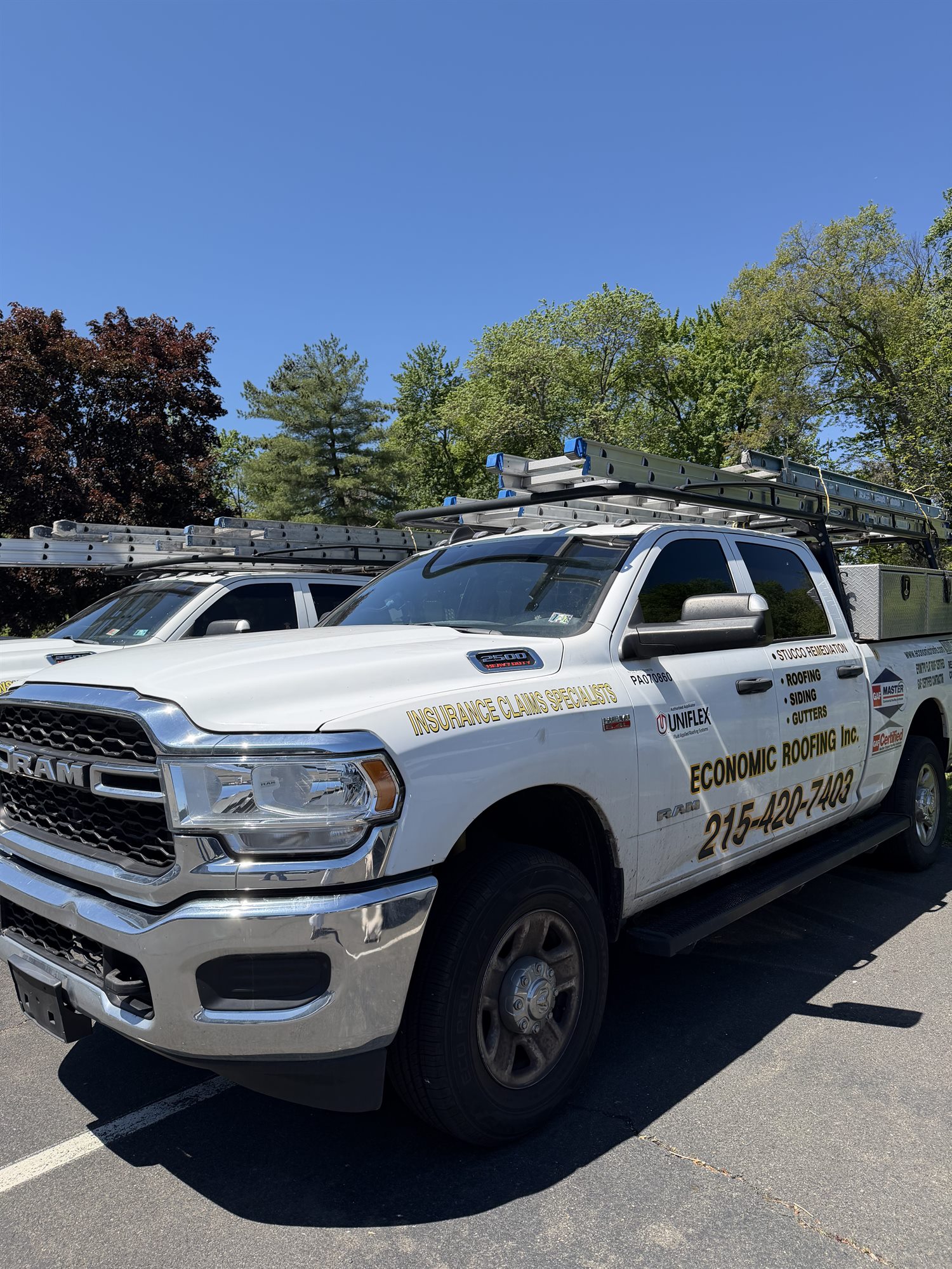 Economic Roofing work truck equipped for roofing and exterior projects